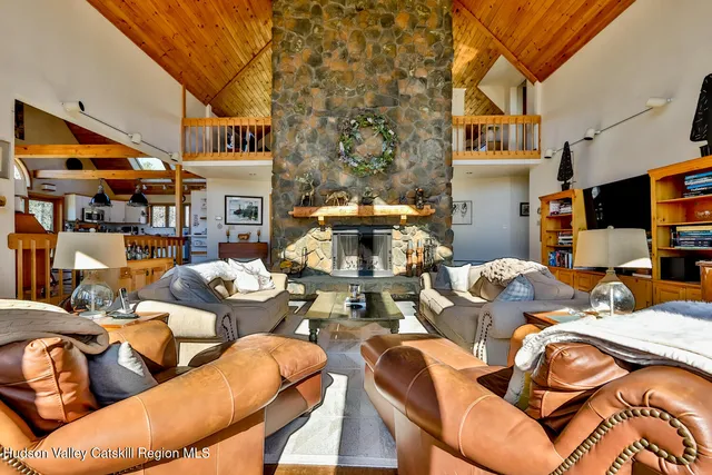 a view of a living room with furniture and a fireplace