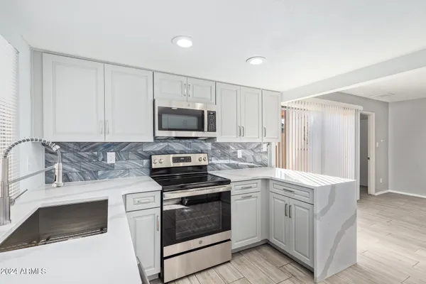 a kitchen with a sink stove and microwave
