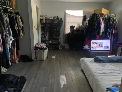 a view of walk in closet with clothes and shoes