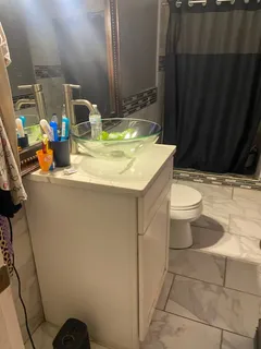 a bathroom with a sink toilet and mirror