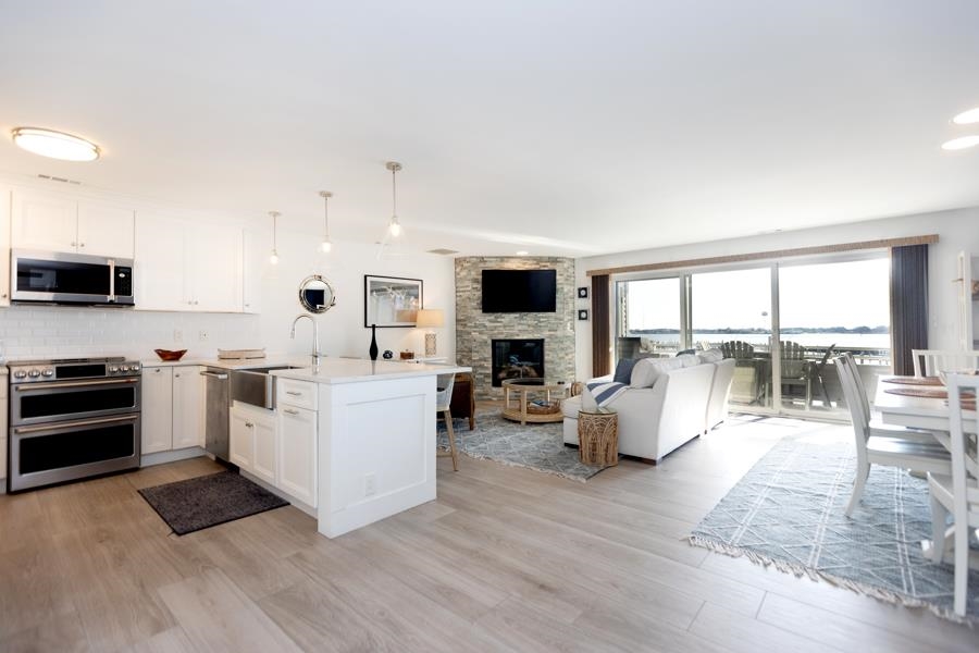 902 Ocean, Unit 906 Cape May, NJ 08204 - Photo 13 of 46 a large white kitchen with a large window a sink and a stove