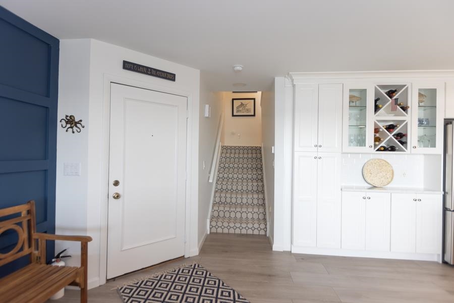 902 Ocean, Unit 906 Cape May, NJ 08204 - Photo 16 of 46 a view of a livingroom with wooden floor and cabinet