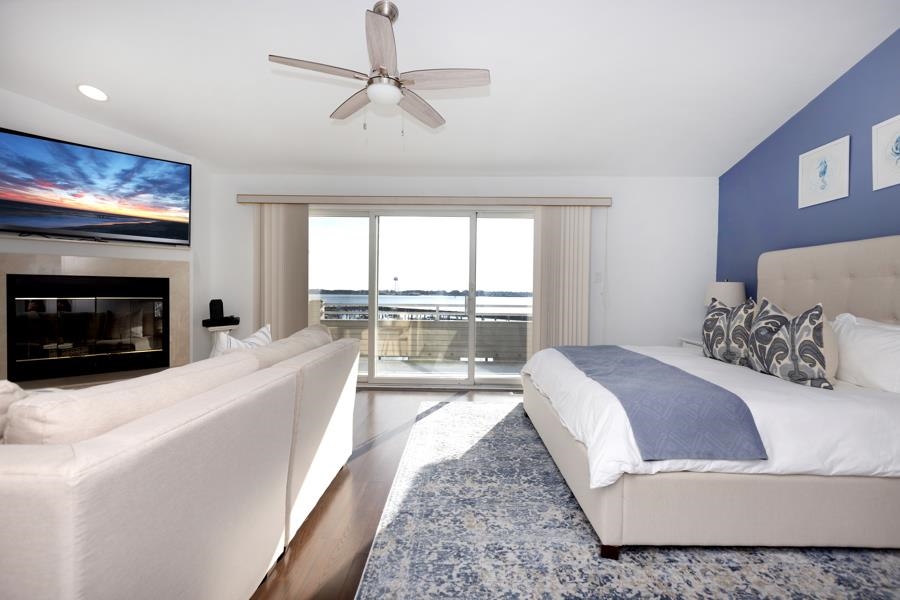 902 Ocean, Unit 906 Cape May, NJ 08204 - Photo 17 of 46 a living room with a balcony furniture and a fireplace