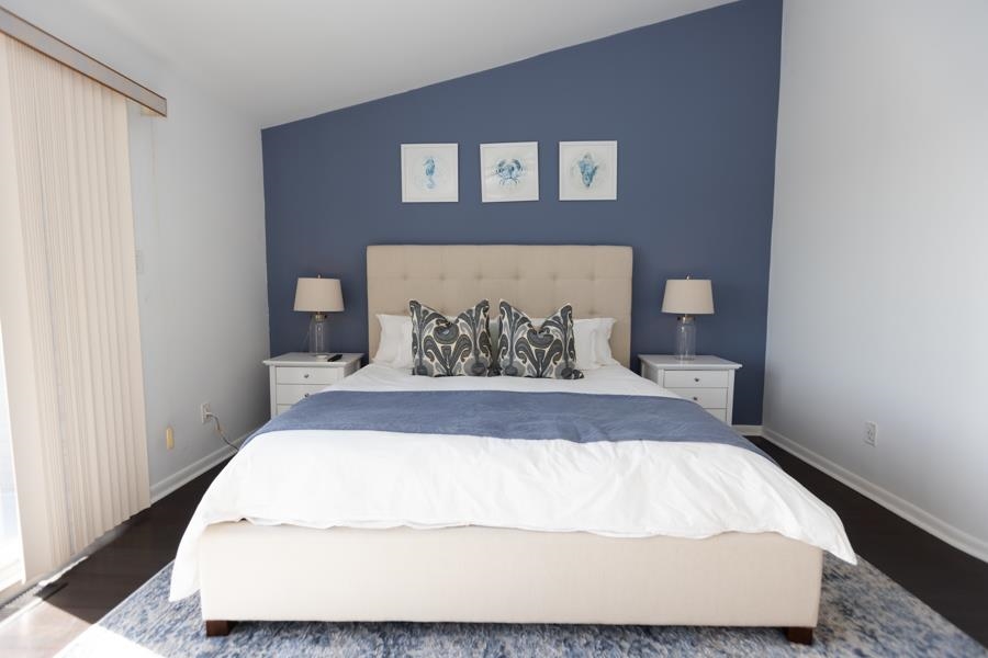 902 Ocean, Unit 906 Cape May, NJ 08204 - Photo 20 of 46 a large bed sitting in a bedroom next to a window