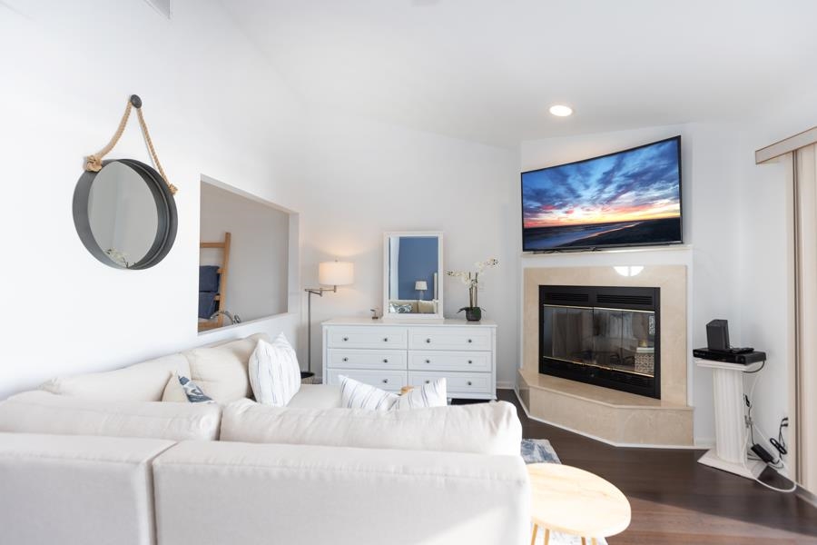 902 Ocean, Unit 906 Cape May, NJ 08204 - Photo 21 of 46 a living room with furniture a fireplace and a flat screen tv