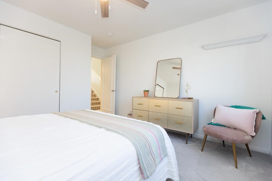 902 Ocean, Unit 906 Cape May, NJ 08204 - Photo 30 of 46 a bedroom with a bed and chair