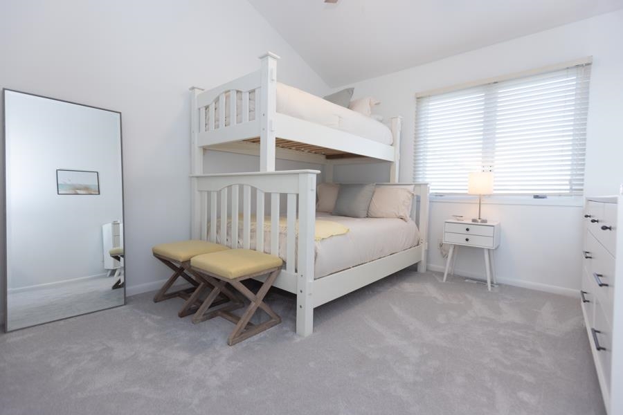 902 Ocean, Unit 906 Cape May, NJ 08204 - Photo 31 of 46 a white bed sitting in a room next to a window