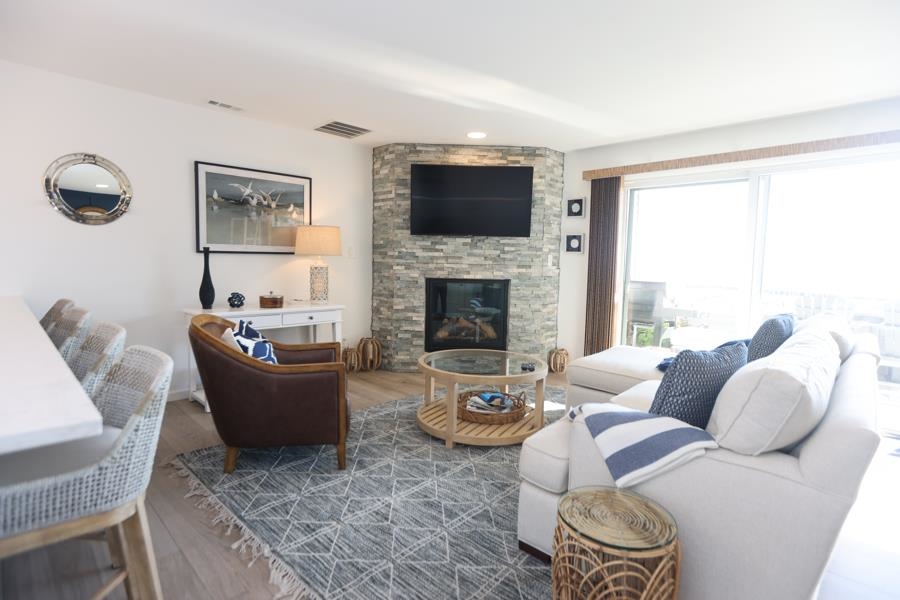 902 Ocean, Unit 906 Cape May, NJ 08204 - Photo 5 of 46 a living room with furniture fireplace and a flat screen tv