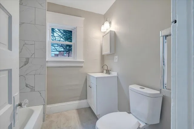 a white toilet sitting next to a bathroom sink