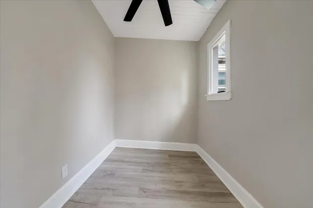 wooden floor in an empty room with a window
