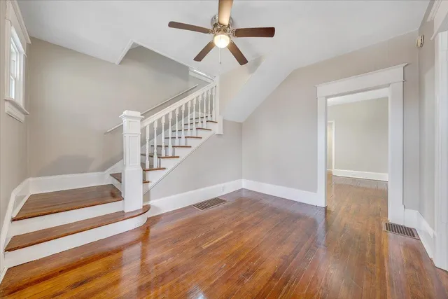 a view of entryway and hall with wooden floor