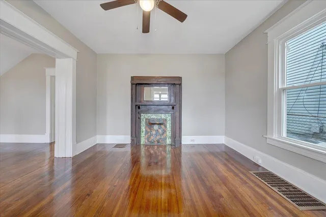 wooden floor in an empty room with a window