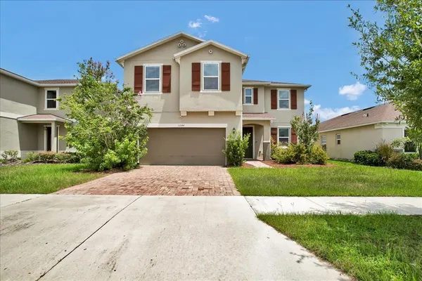 a front view of a house with a yard and garage