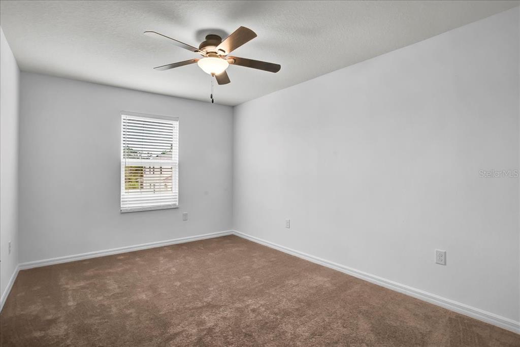 11544 Brighton Knoll Loop Riverview, FL 33579 - Photo 18 of 65 an empty room with a window and a fan