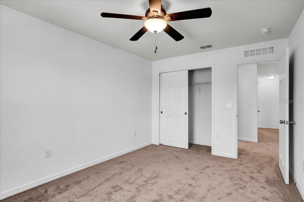 11544 Brighton Knoll Loop Riverview, FL 33579 - Photo 19 of 65 an empty room with closet and a chandelier fan