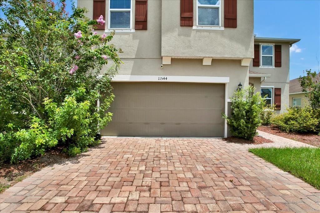 11544 Brighton Knoll Loop Riverview, FL 33579 - Photo 2 of 65 a front view of a building with a garden