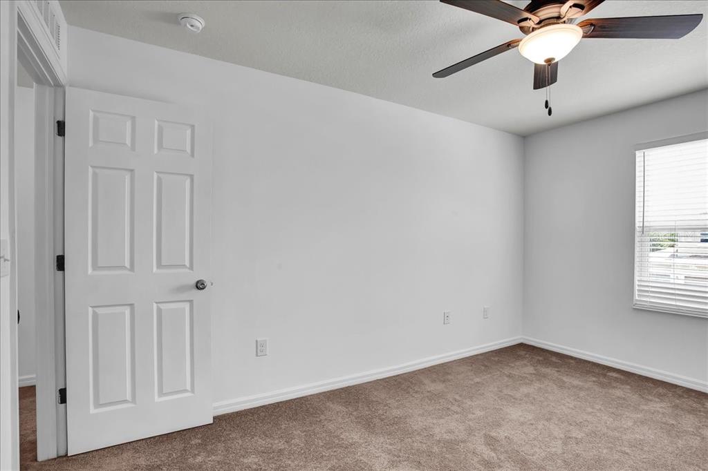 11544 Brighton Knoll Loop Riverview, FL 33579 - Photo 21 of 65 an empty room with windows and fan
