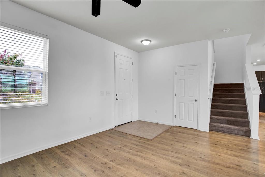 11544 Brighton Knoll Loop Riverview, FL 33579 - Photo 32 of 65 a view of an empty room with wooden floor and windows