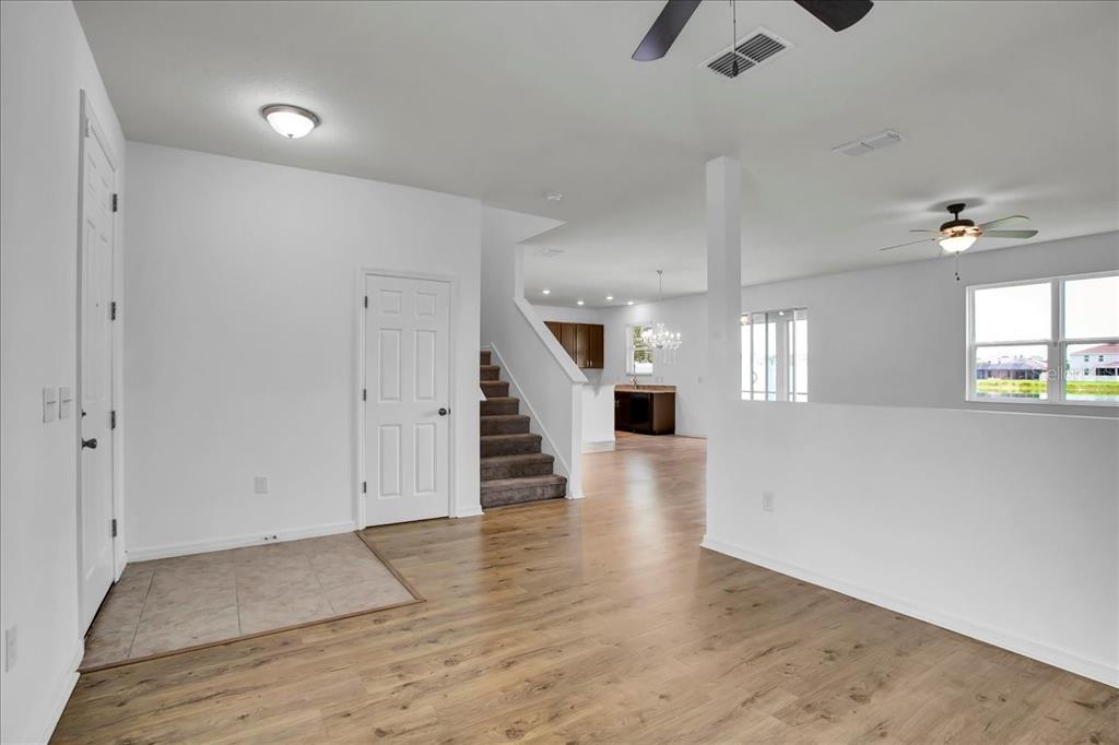 11544 Brighton Knoll Loop Riverview, FL 33579 - Photo 33 of 65 an empty room with wooden floor and windows