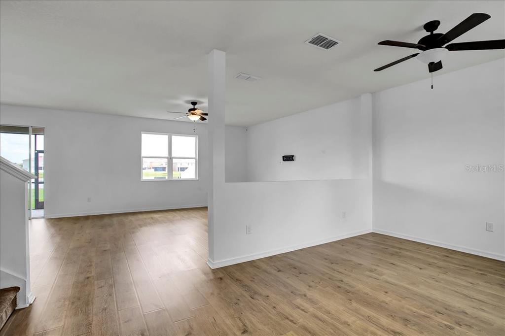11544 Brighton Knoll Loop Riverview, FL 33579 - Photo 34 of 65 an empty room with wooden floor fan and windows