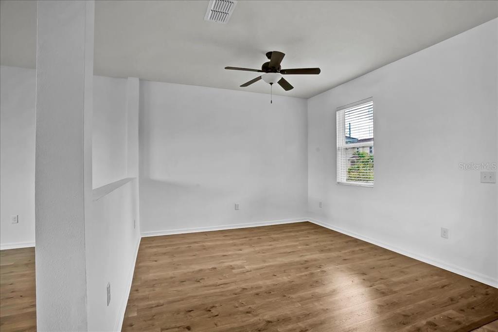 11544 Brighton Knoll Loop Riverview, FL 33579 - Photo 35 of 65 an empty room with a window and a ceiling fan