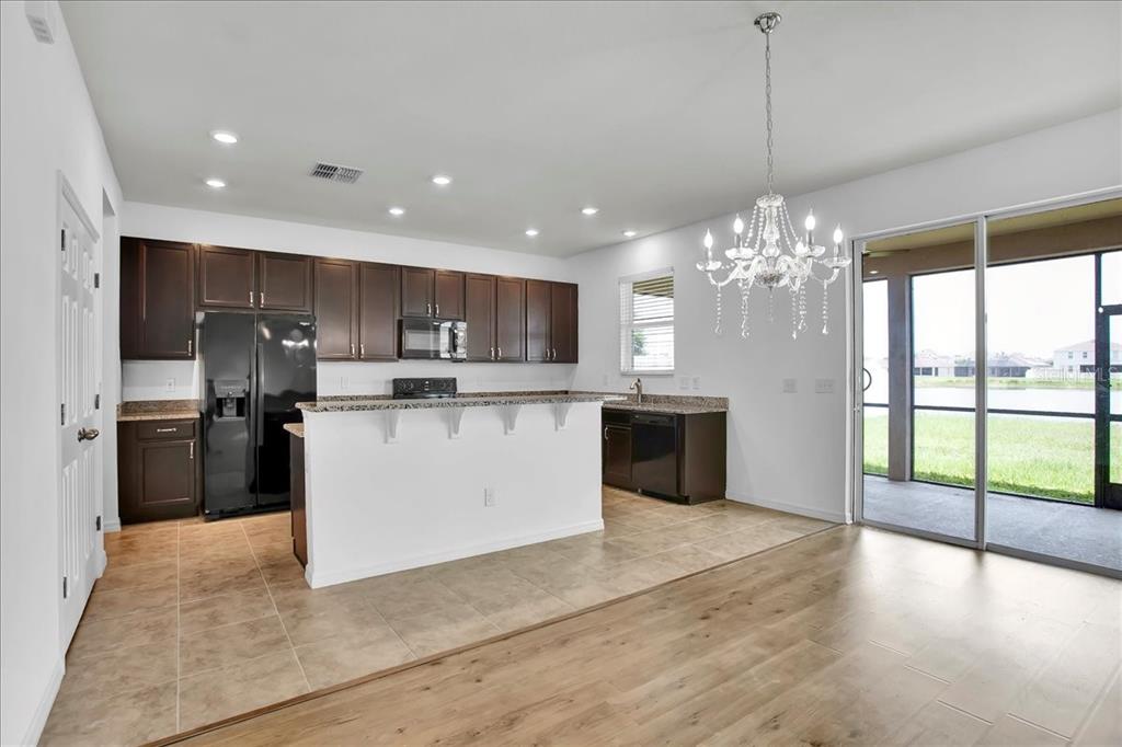 11544 Brighton Knoll Loop Riverview, FL 33579 - Photo 41 of 65 a large kitchen with kitchen island a large counter top a sink stainless steel appliances and cabinets