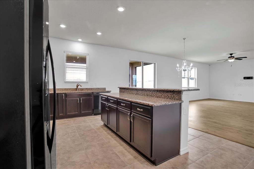 11544 Brighton Knoll Loop Riverview, FL 33579 - Photo 43 of 65 a kitchen with stainless steel appliances granite countertop a stove a sink and a refrigerator