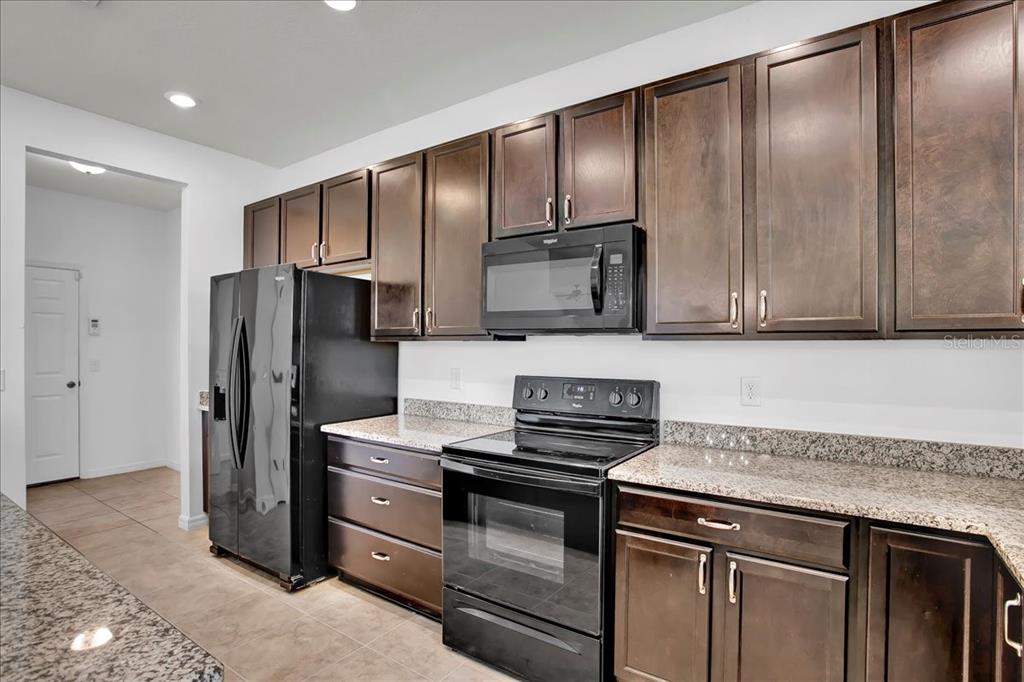 11544 Brighton Knoll Loop Riverview, FL 33579 - Photo 44 of 65 a kitchen with stainless steel appliances granite countertop a refrigerator and a sink