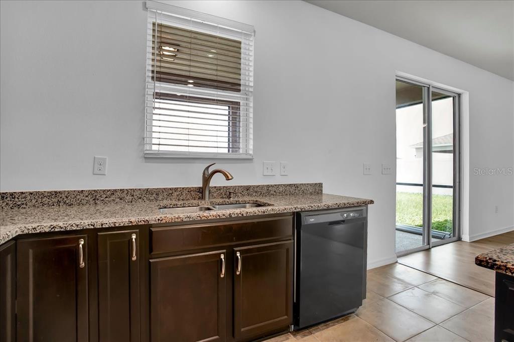 11544 Brighton Knoll Loop Riverview, FL 33579 - Photo 46 of 65 a kitchen with a granite countertop sink a window and a dishwasher