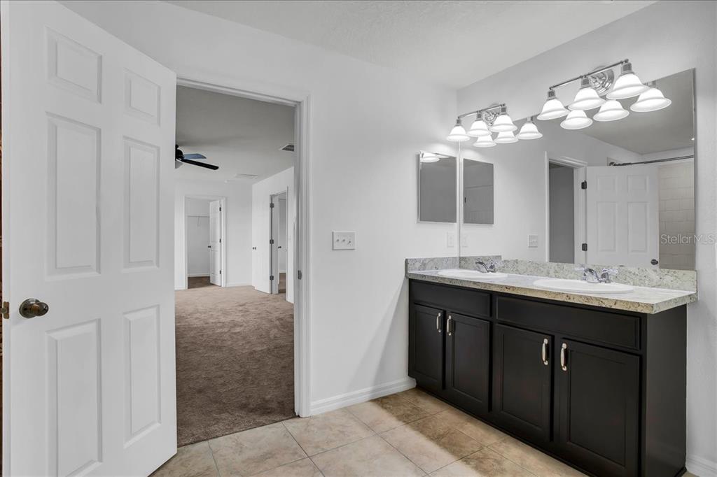 11544 Brighton Knoll Loop Riverview, FL 33579 - Photo 55 of 65 a spacious bathroom with a sink and a mirror