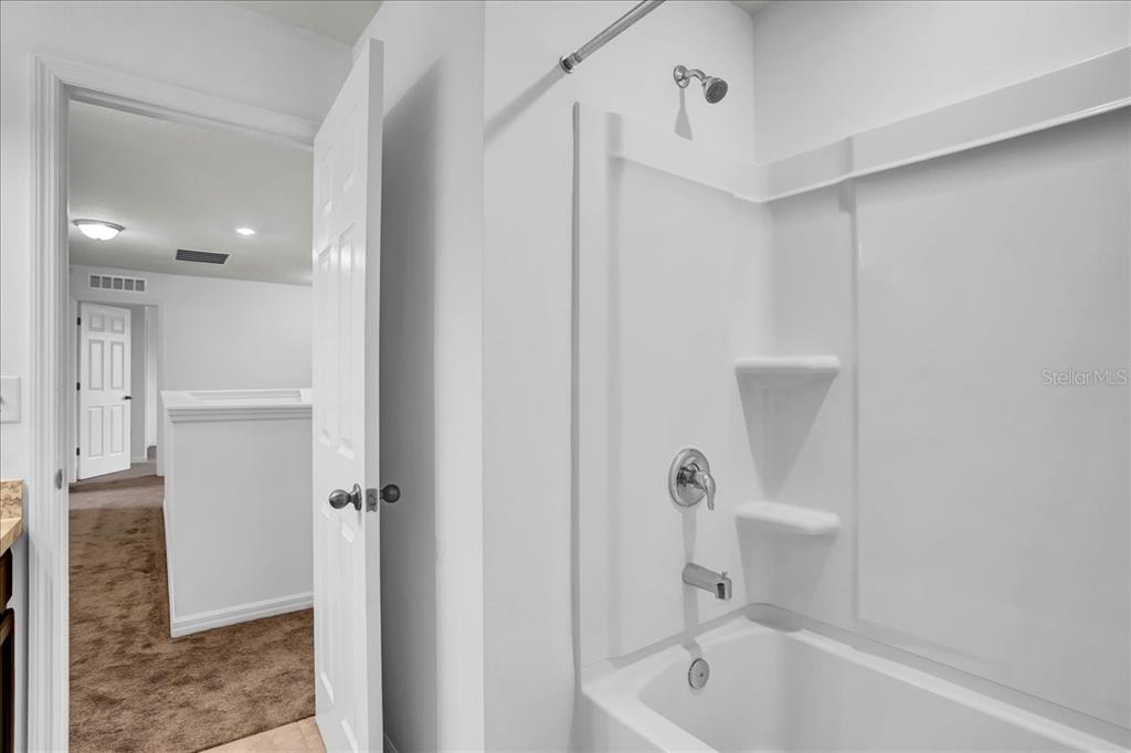 11544 Brighton Knoll Loop Riverview, FL 33579 - Photo 60 of 65 a bathroom with a tub shower and toilet