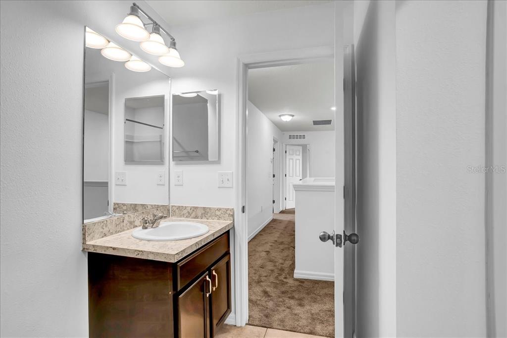 11544 Brighton Knoll Loop Riverview, FL 33579 - Photo 61 of 65 a bathroom with a sink and a mirror