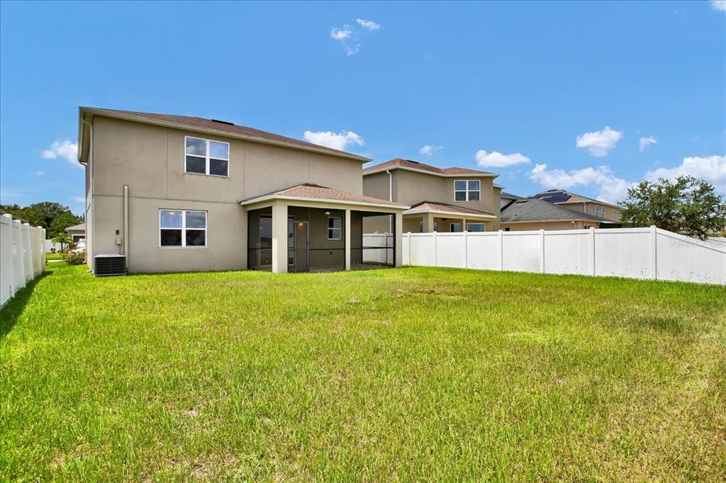 11544 Brighton Knoll Loop Riverview, FL 33579 - Photo 9 of 65 a view of a yard with table and chairs and wooden fence