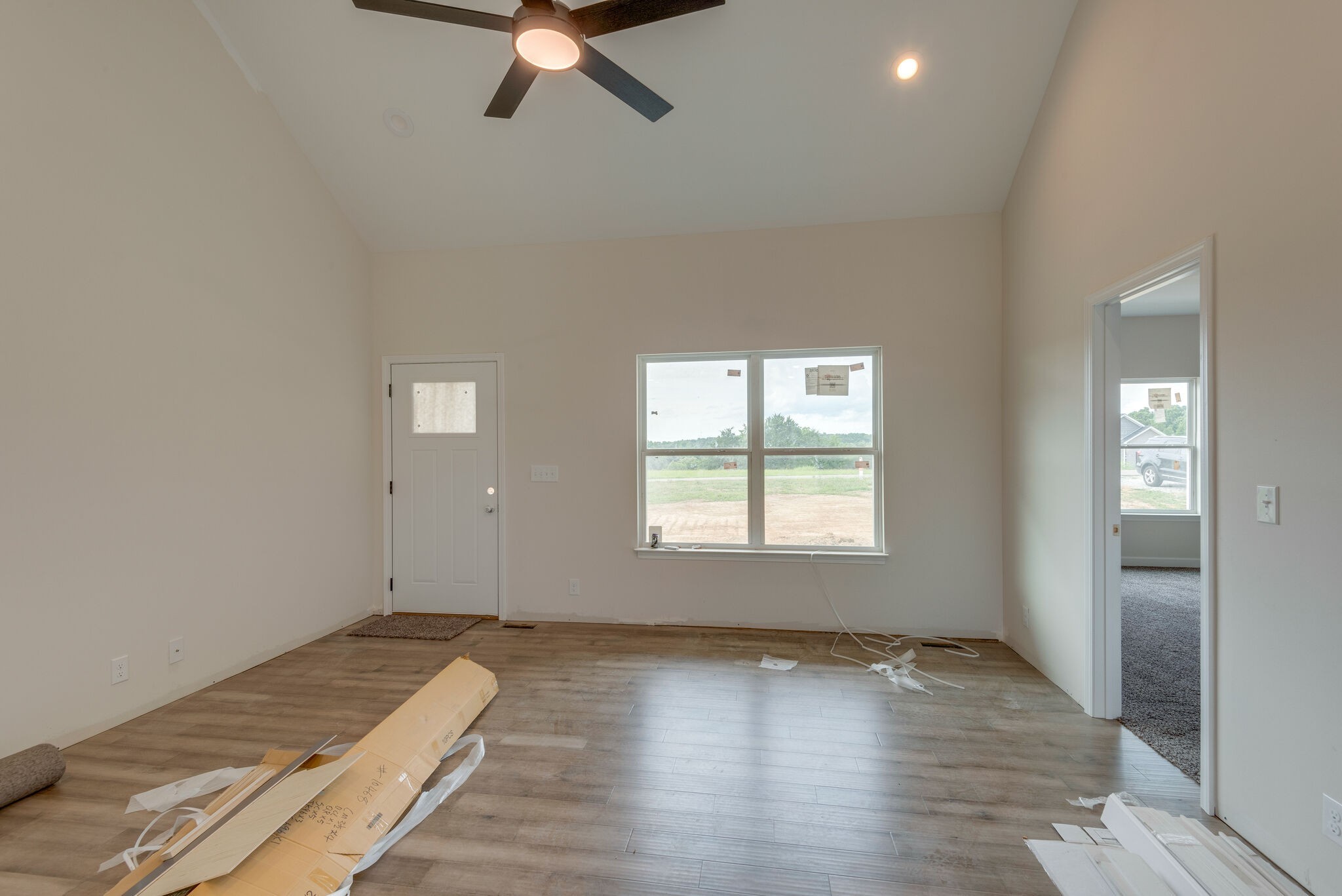 1202 Oak Grove Road Dickson, TN 37055 - Photo 5 of 28 an empty room with wooden floor and windows