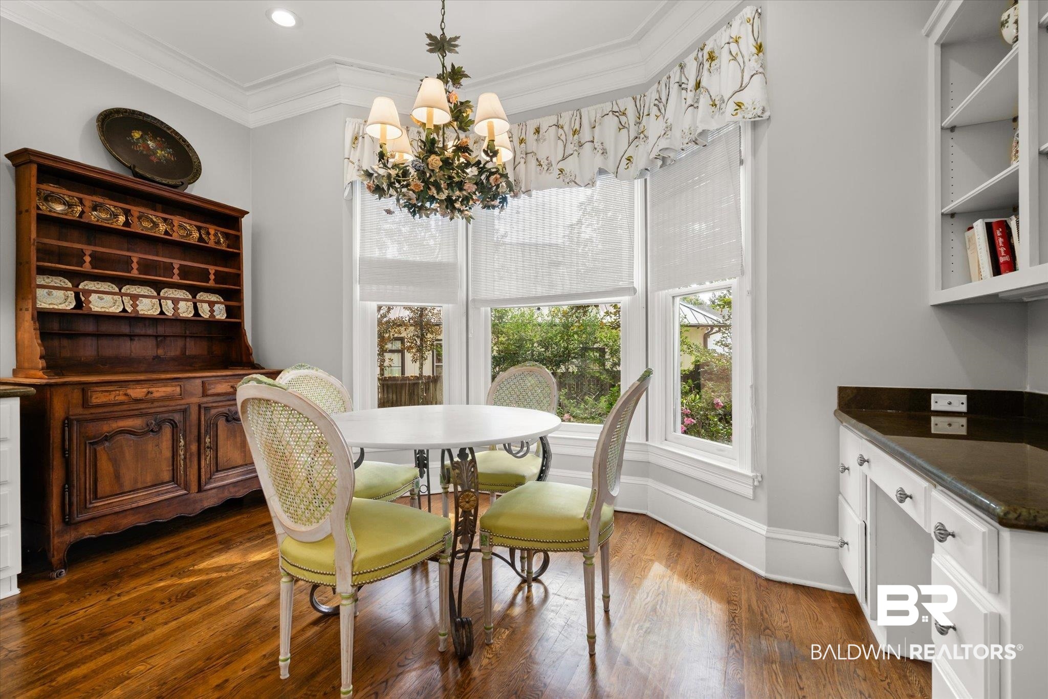 354 Dogwood Lane Mobile, AL 36608 - Photo 16 of 44 Dining area with crown molding, a chandelier, and dark hardwood / wood-style floors