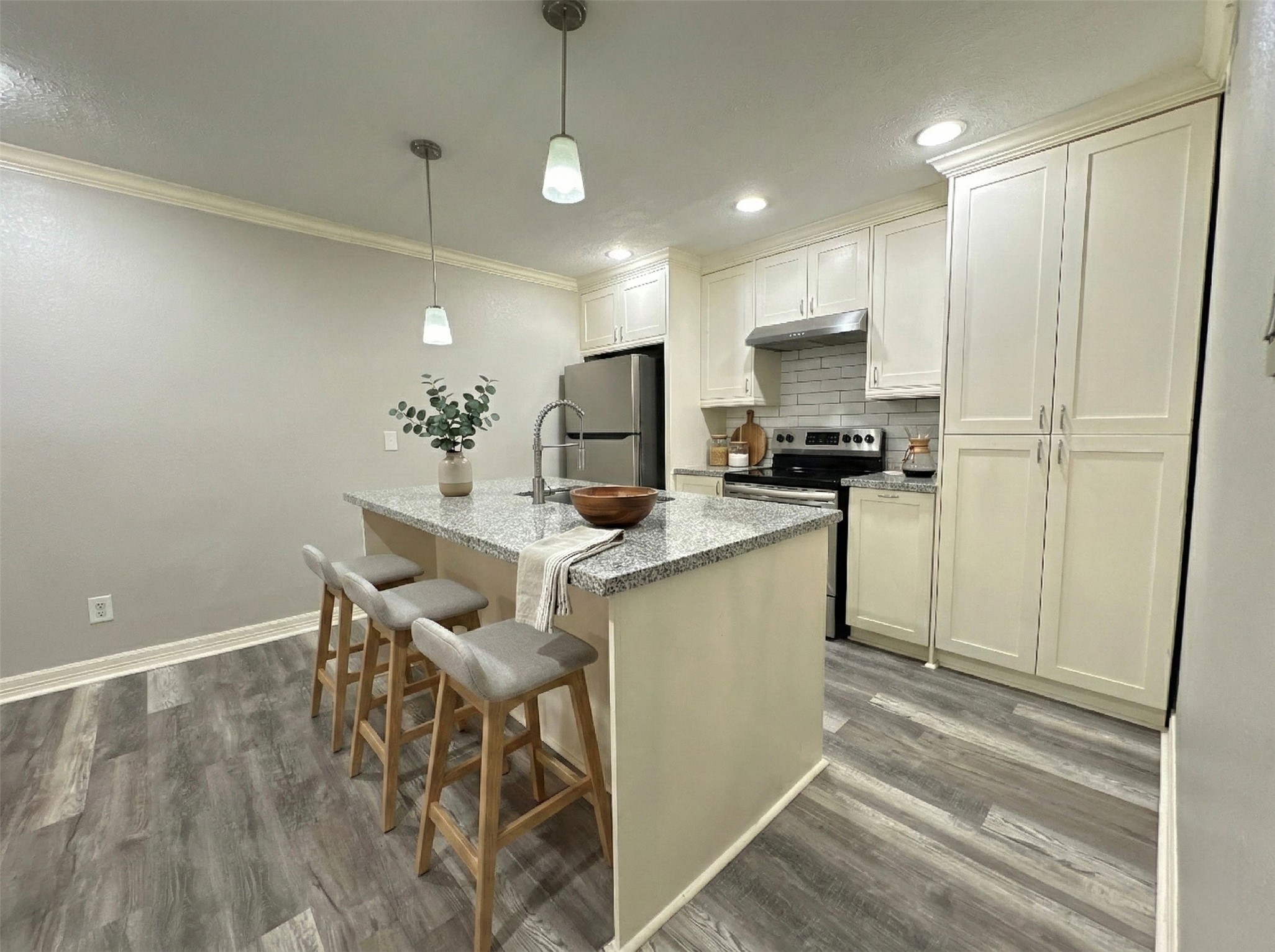 7303 Gulf Freeway, Unit 903 Houston, TX 77017 - Photo 2 of 15 a kitchen with stainless steel appliances kitchen island granite countertop a sink a stove a refrigerator cabinets and a dining table