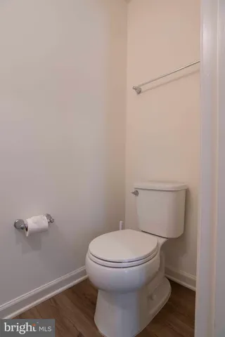 a white toilet sitting next to a shower