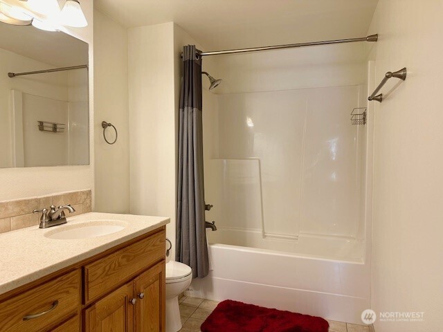 1548 River Road, Unit 105 Longview, WA 98632 - Photo 13 of 25 a bathroom with a granite countertop sink a mirror a shower and a bathtub