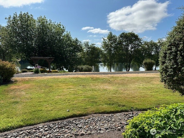 1548 River Road, Unit 105 Longview, WA 98632 - Photo 19 of 25 a house view with swimming pool and trees in the background