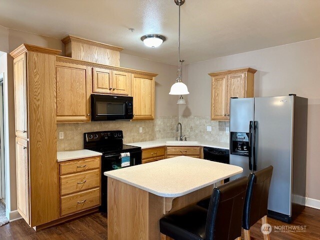 1548 River Road, Unit 105 Longview, WA 98632 - Photo 6 of 25 a kitchen with a sink a counter space stainless steel appliances and cabinets