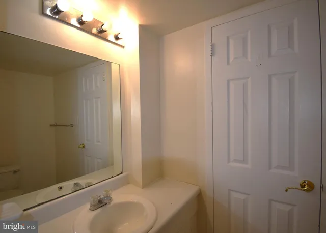 a bathroom with a sink and mirror