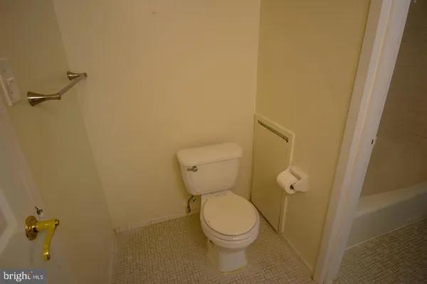 a white toilet sitting next to a shower
