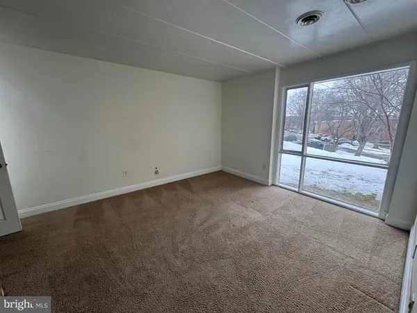 a view of an empty room with a sliding door