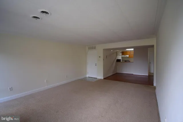 a view of an empty room and bathroom
