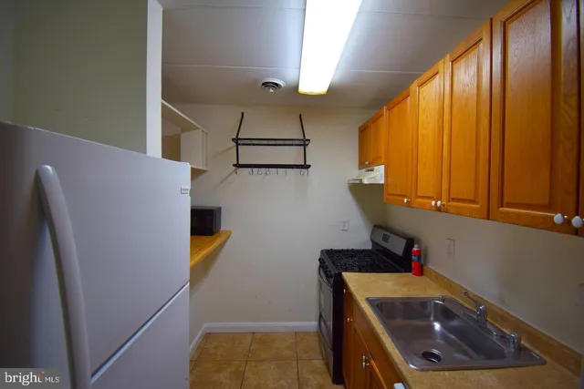 a view of storage and utility room with a sink
