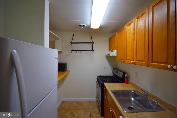 a view of storage and utility room with a sink