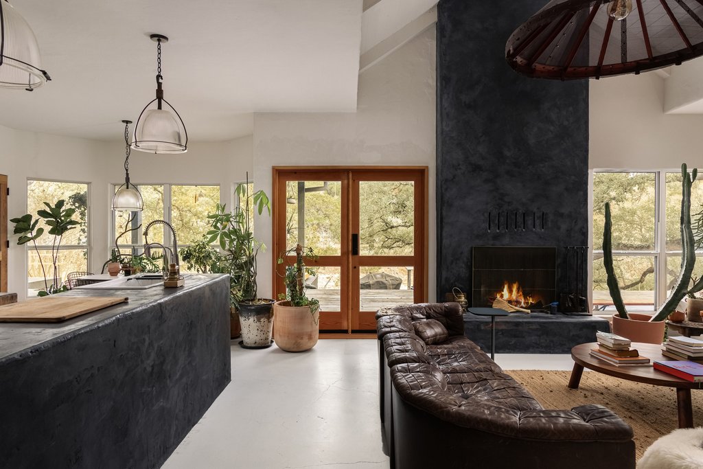 412 Rancho Grande Drive Wimberley, TX 78676 - Photo 11 of 37 Living area with a fireplace, concrete floors, plenty of natural light, and high vaulted ceiling