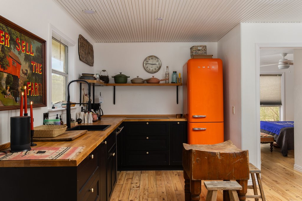 412 Rancho Grande Drive Wimberley, TX 78676 - Photo 24 of 37 Kitchen with wooden counters, dark cabinetry, light wood-style floors, and open shelves
