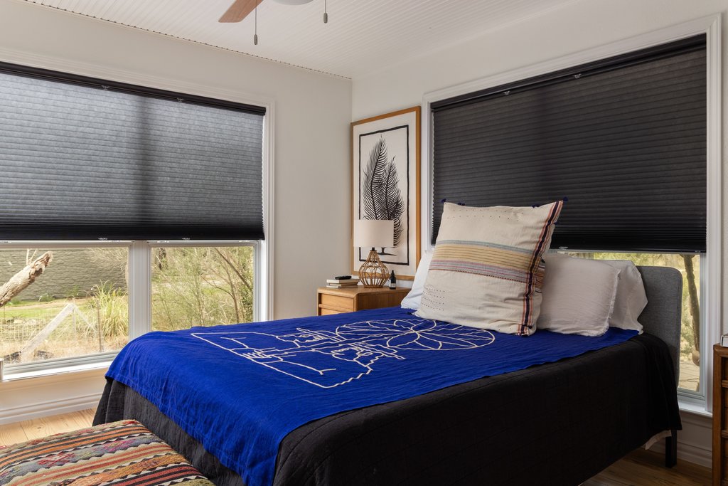 412 Rancho Grande Drive Wimberley, TX 78676 - Photo 25 of 37 Bedroom featuring wood finished floors, a ceiling fan, and multiple windows