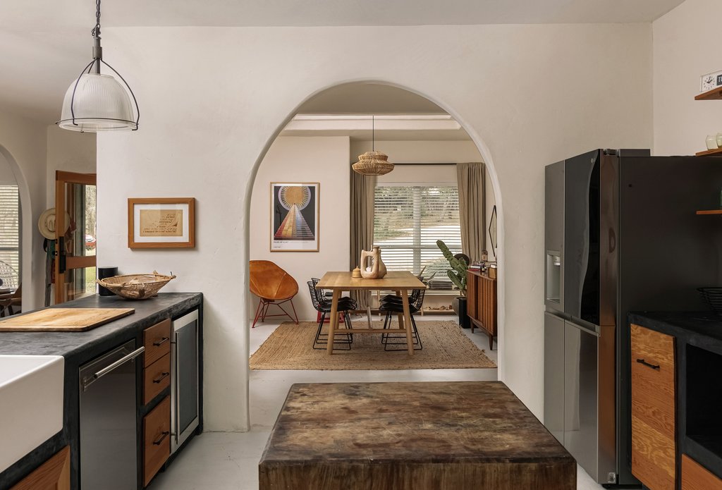 412 Rancho Grande Drive Wimberley, TX 78676 - Photo 7 of 37 Kitchen featuring dark countertops, arched walkways, appliances with stainless steel finishes, beverage cooler, and decorative light fixtures